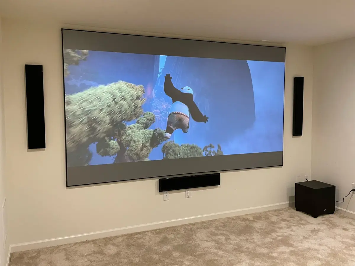 Large projector screen with in-wall speakers and subwoofer